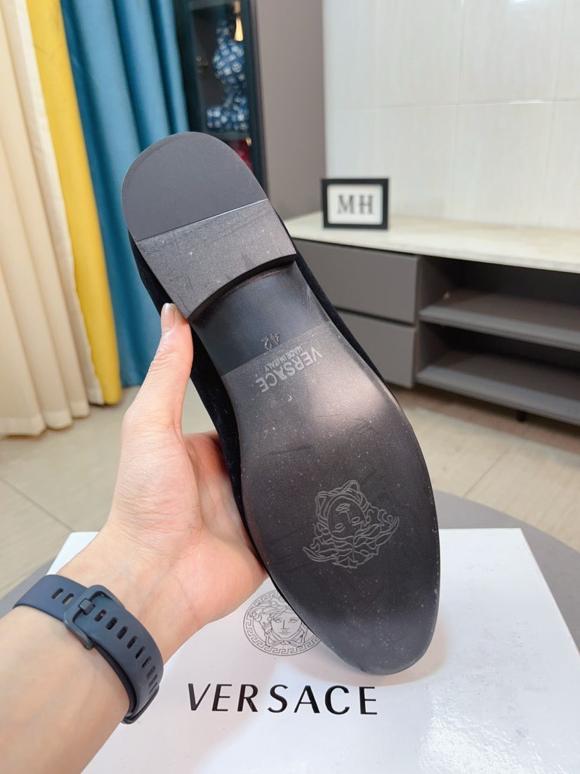Black leather underside of loafer with embossed brand marks