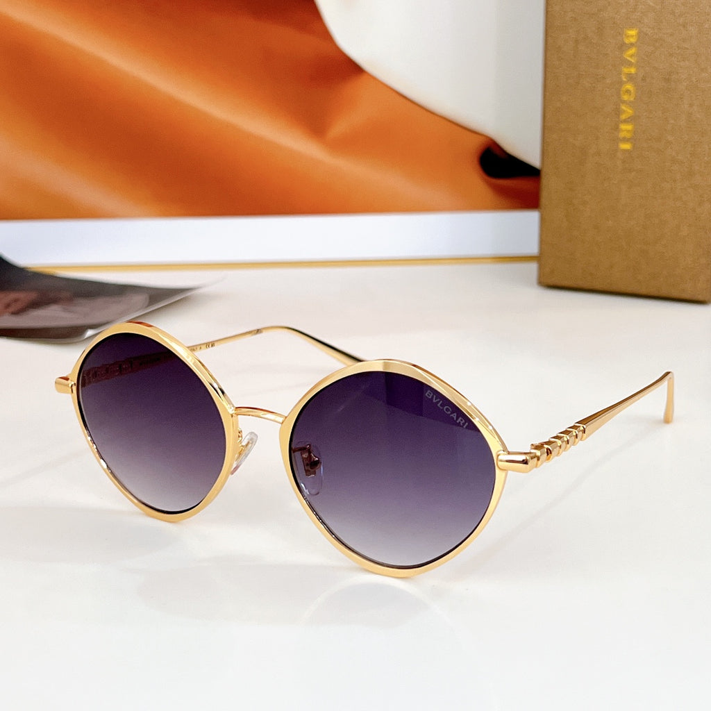 Round sunglasses with gold-tone frame and mirrored purple lenses, gold-tone temples.