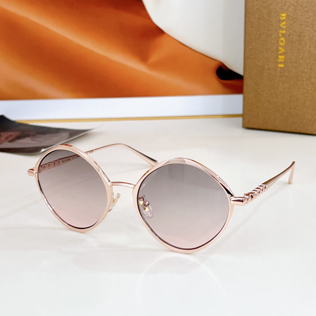 Round sunglasses with rose-pink frame and pale mirrored lenses, gold-tone temples.