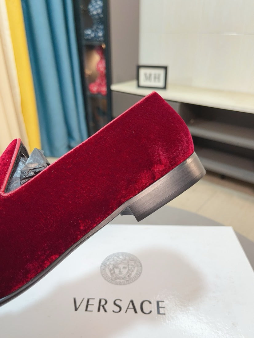 Burgundy velvet loafer with low heel and slip-on design, side view