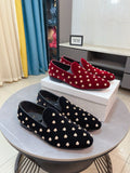 Velvet loafers by Versace, deep red with gold stud embellishments and slip-on design.