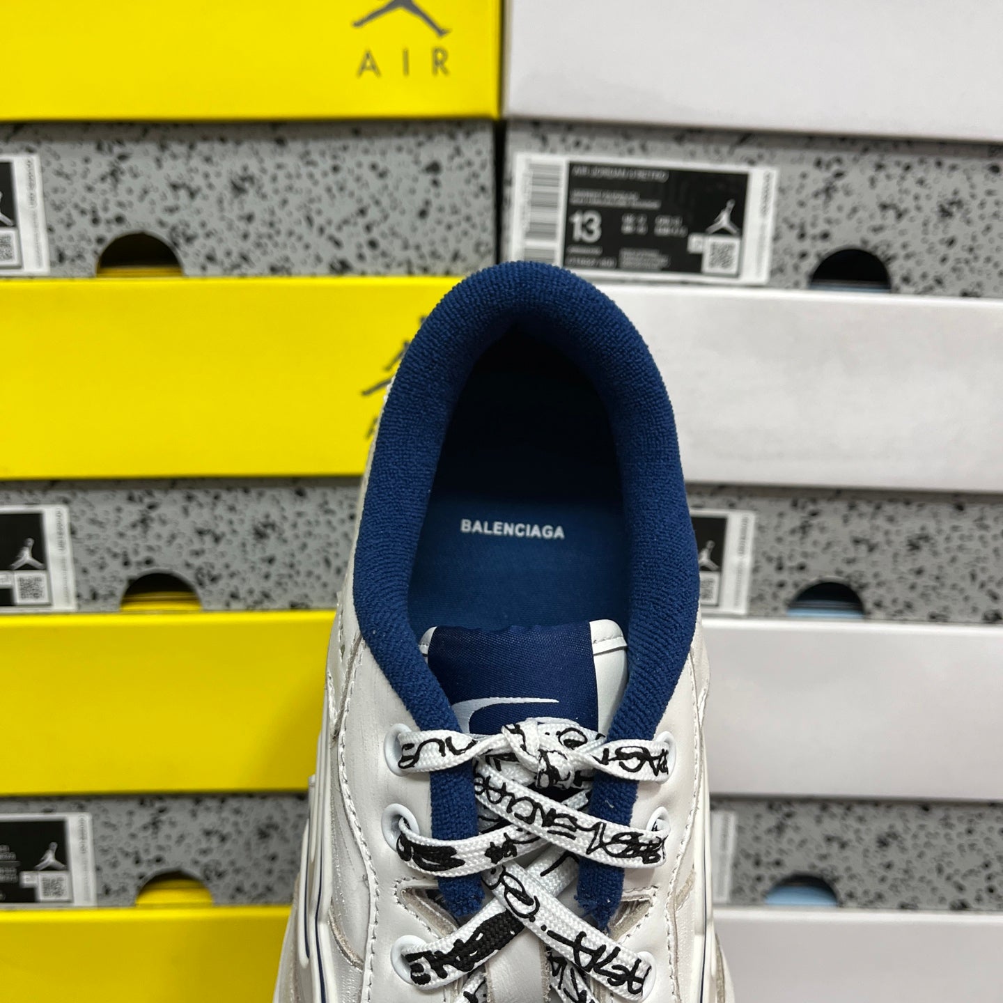 White Balenciaga unisex sneaker with blue heel collar and lace-up front
