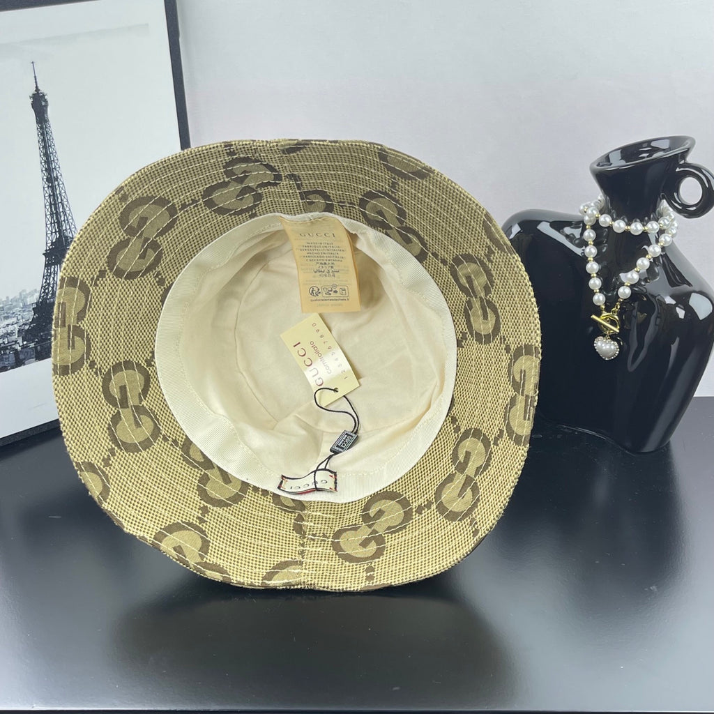 Gucci GG monogram bucket hat with beige outer shell and visible white inner lining