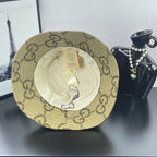 Gucci GG monogram bucket hat with beige outer shell and visible white inner lining
