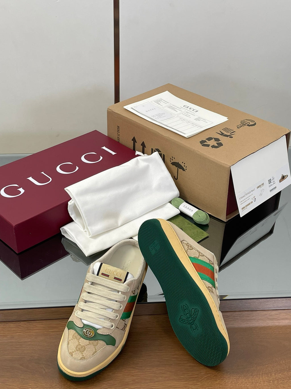 Low-top sneaker pair with beige canvas, green outsole, white laces, side view