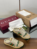 Gucci low-top sneakers in beige with green and red web stripe detail, lace-up.