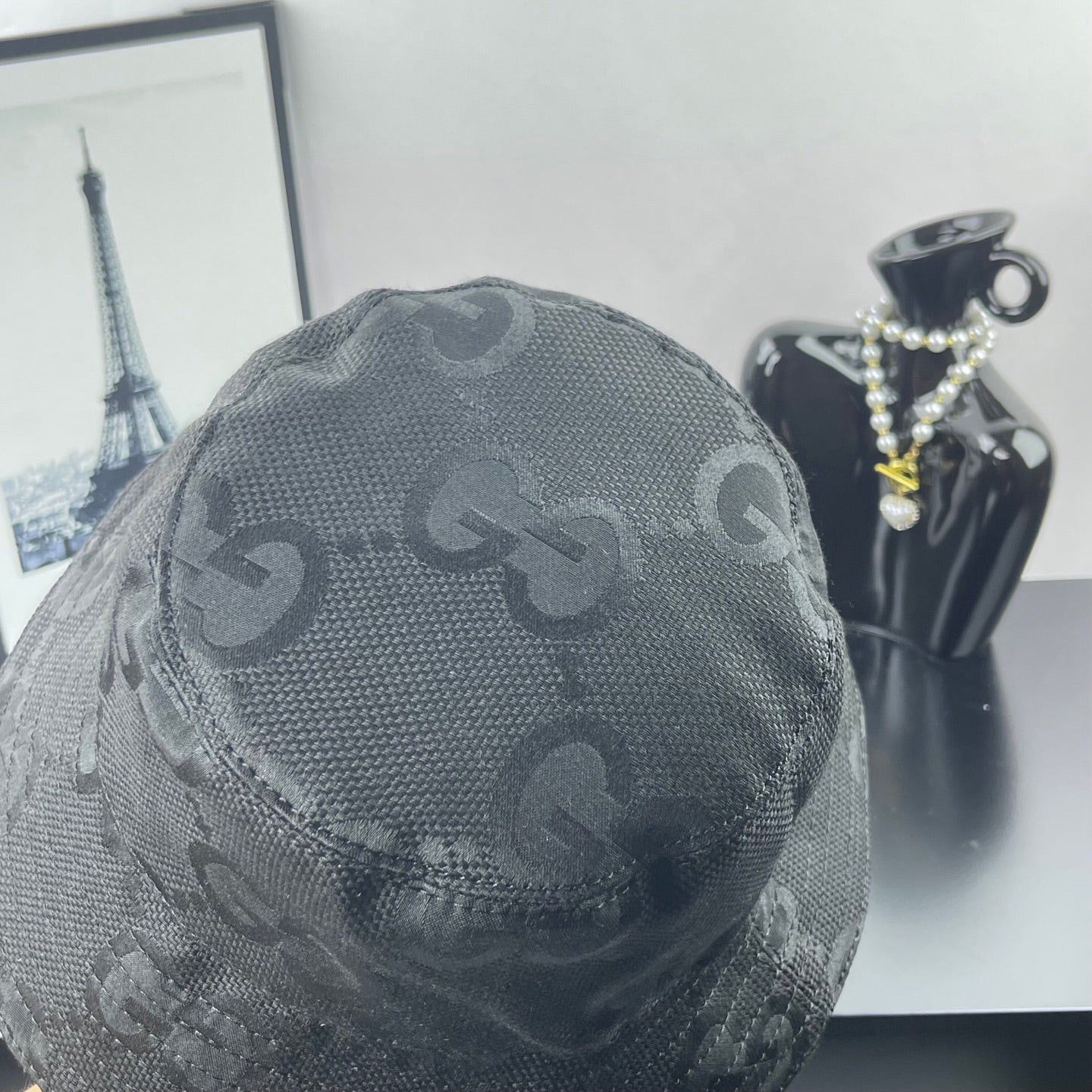 Gucci bucket hat dark gray with close-up GG monogram pattern and top panel seam