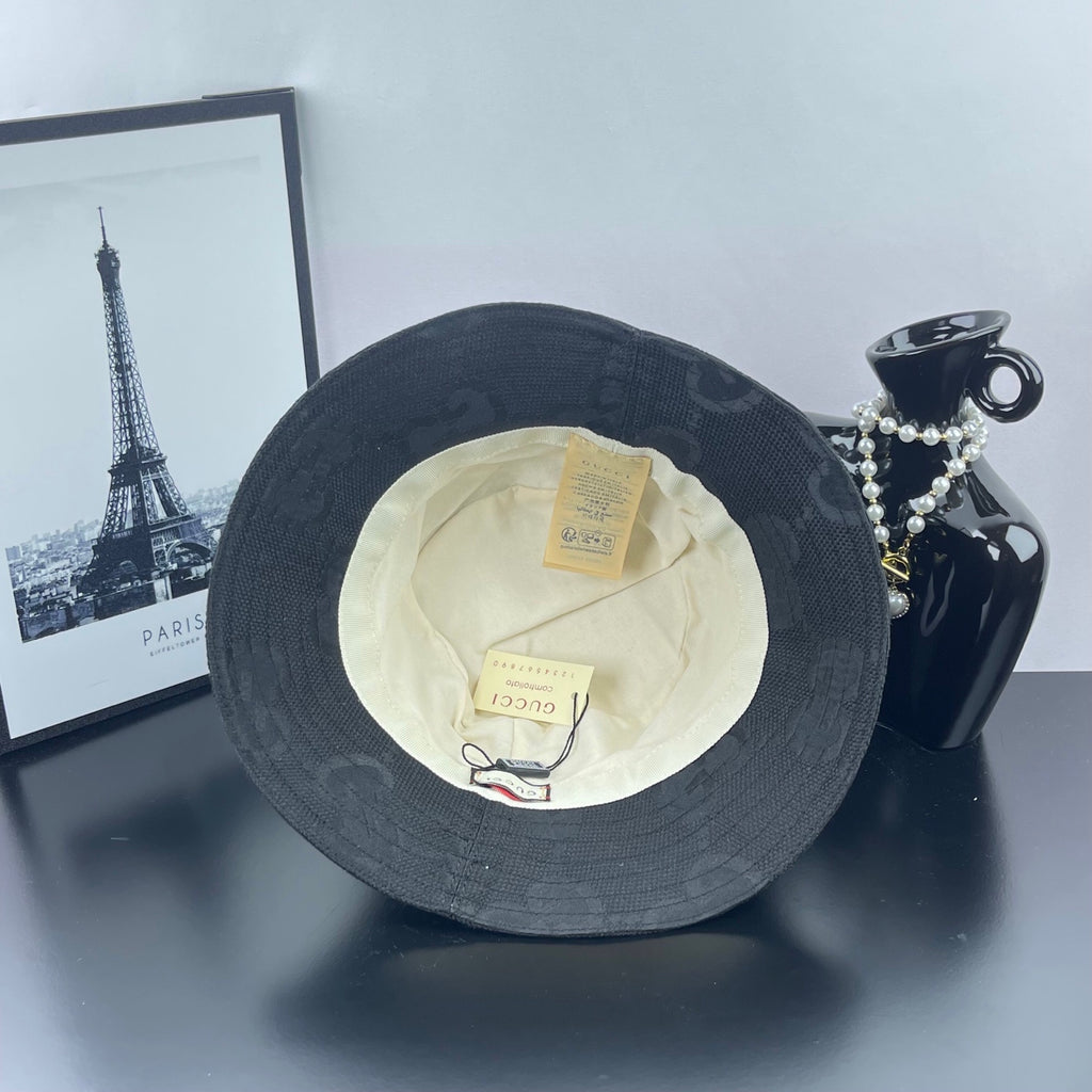 Gucci bucket hat dark gray, inside view with cream lining and visible fabric labels