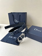 Dior belt with dark blue monogram strap, gold buckle, and perforated tail end