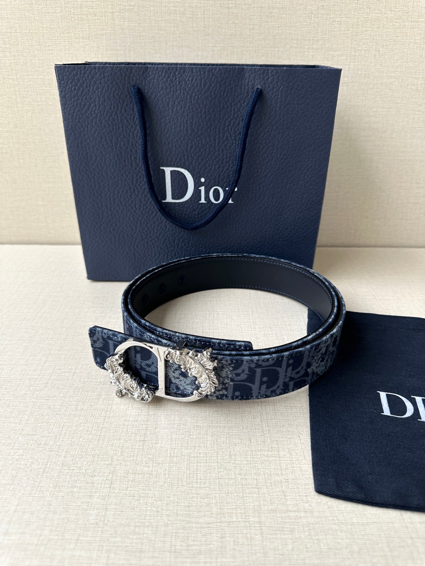 Dior belt with dark blue monogram strap and gold buckle detail