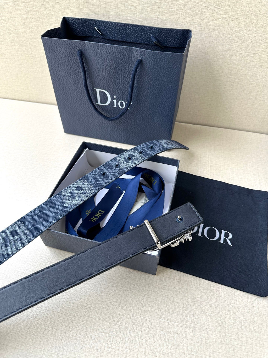 Dior belt with dark blue monogram strap and silver-toned buckle on long tail