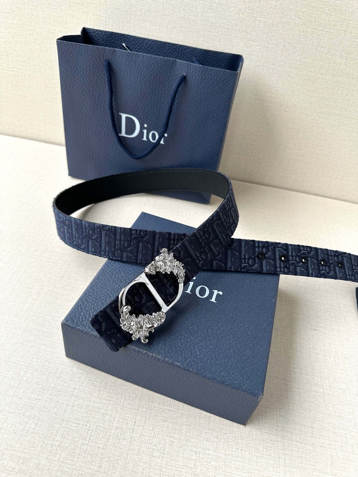 Dior belt with dark blue monogram strap and silver buckle with oval centerpiece