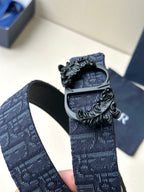Dior belt buckle close-up on dark blue strap with textured black centerpiece