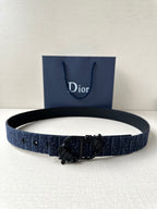 Dior belt in dark blue fabric with black ornate buckle and keeper tabs