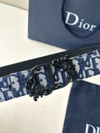 Dior belt close-up with woven monogram band and black end buckle