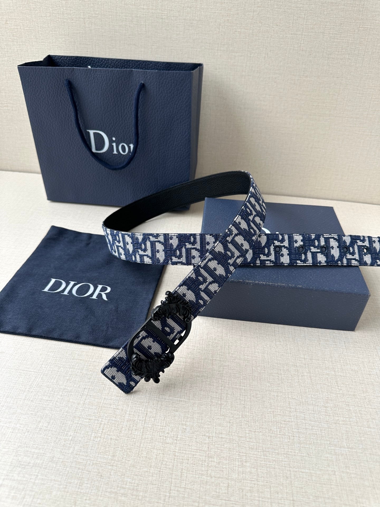 Dior belt with monogram strap and black clasp on dark leather base