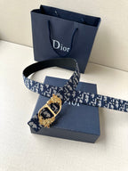Dior belt with navy logo canvas strap and ornate gold-tone buckle detail
