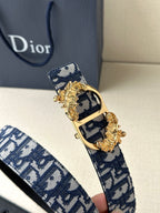 Dior belt close-up with navy logo strap and gold-tone buckle with decorative edges