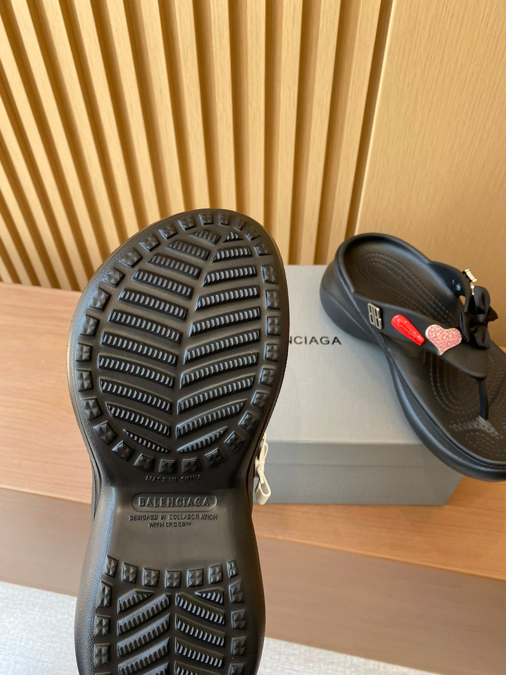 Black sandal outsoles with tread pattern, rear views of thong sandals