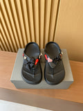 Black Balenciaga flip-flops with heart and ribbon charms, double-thong design