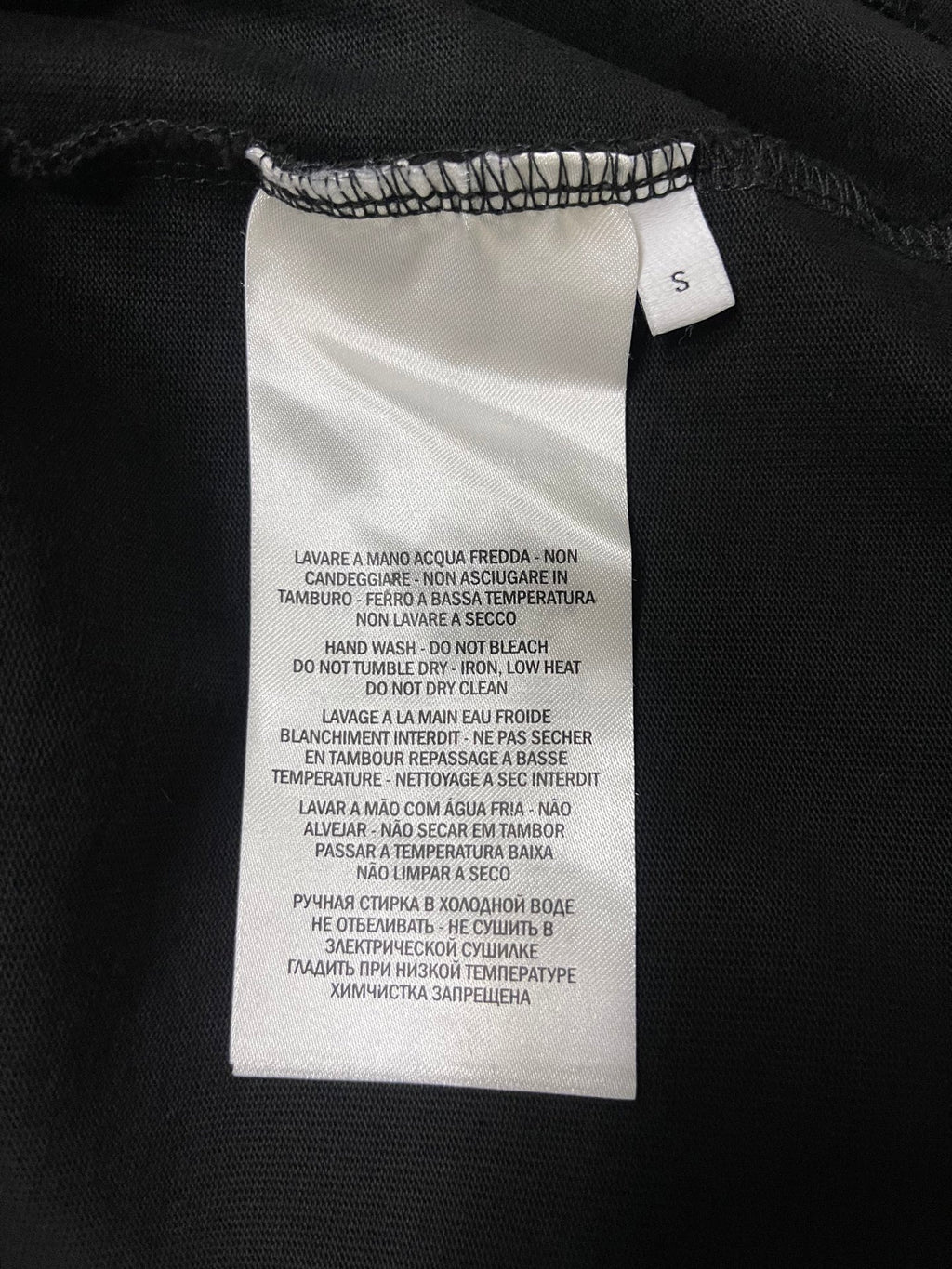 Black T-shirt care label tag at collar