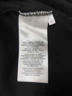 Black T-shirt care label tag at collar