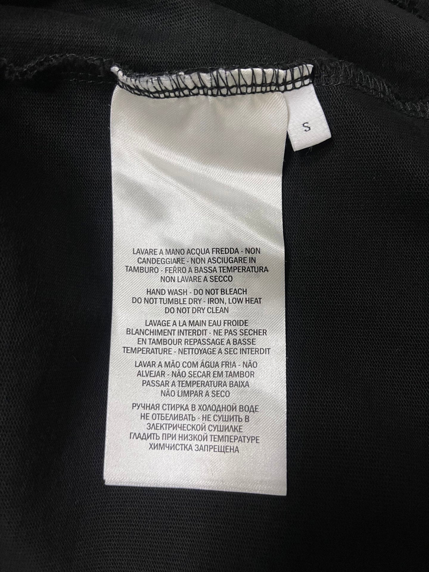 Black T-shirt care label tag at collar