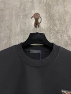 Black T-shirt neckline with inner brand tag and Prada insignia