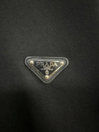 Black knit T-shirt with Prada triangle logo patch
