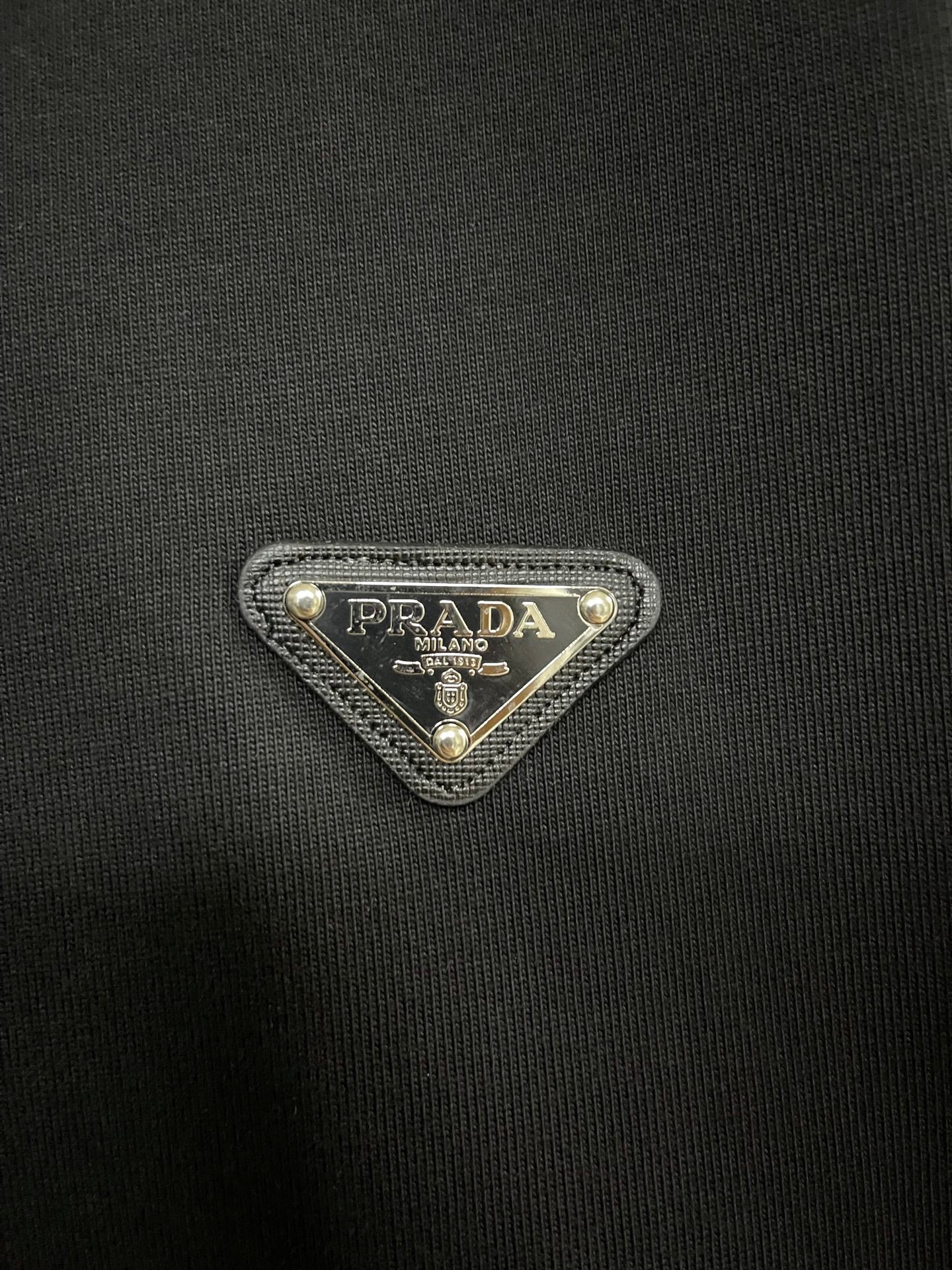Black knit T-shirt with Prada triangle logo patch