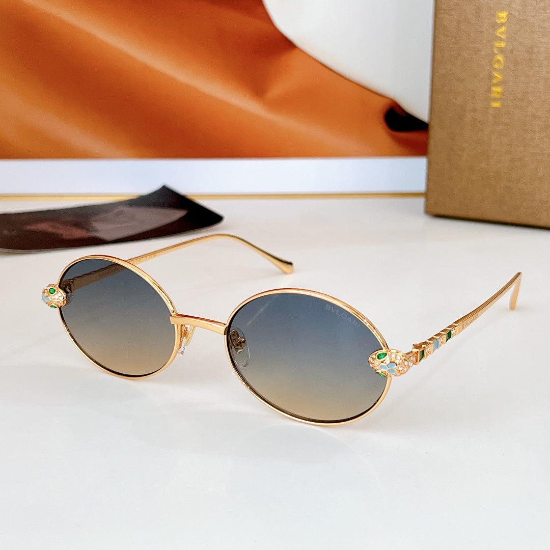 Gold round sunglasses with smoky dark lenses and multicolor jeweled temple detail