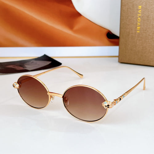 Gold round sunglasses with dark brown lenses and jeweled temple accents