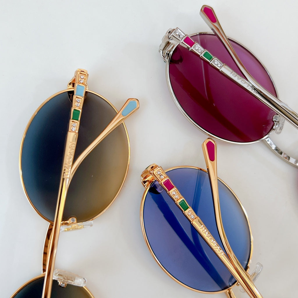 Assorted color sunglasses with gold frames and gemstone-like temple accents