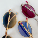 Assorted color sunglasses with gold frames and gemstone-like temple accents