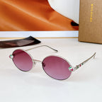 Silver round sunglasses with pink lenses and jeweled, multicolor temple accents