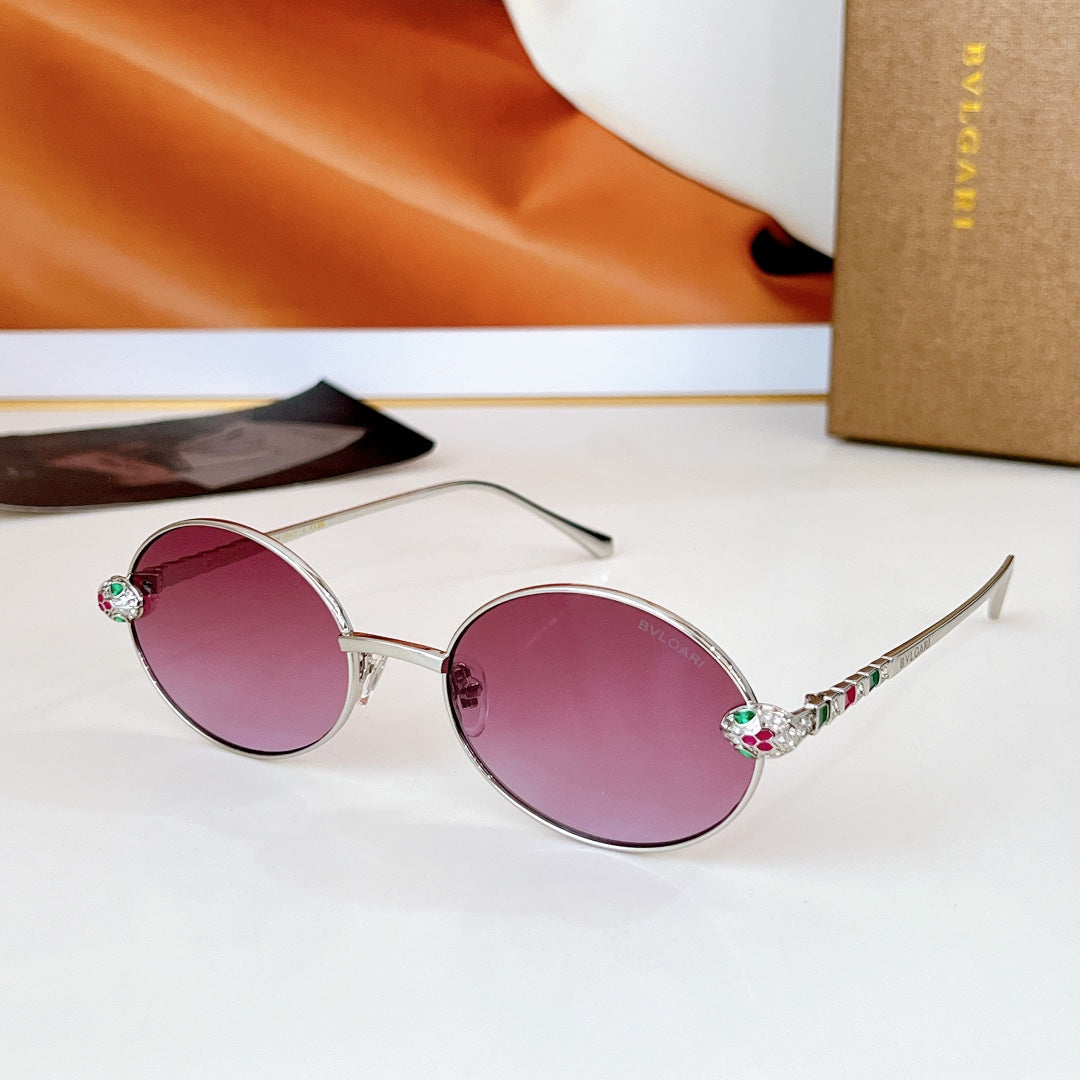 Silver round sunglasses with pink lenses and jeweled, multicolor temple accents