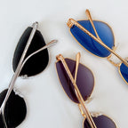 Cat-eye sunglasses with mixed silver and gold frames and blue or purple gradient lenses