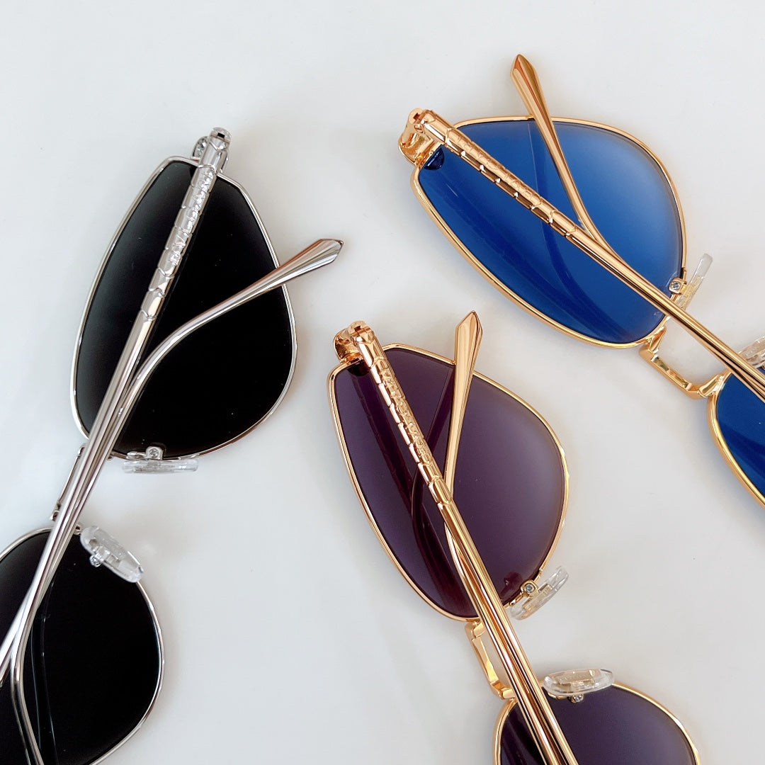 Cat-eye sunglasses with mixed silver and gold frames and blue or purple gradient lenses