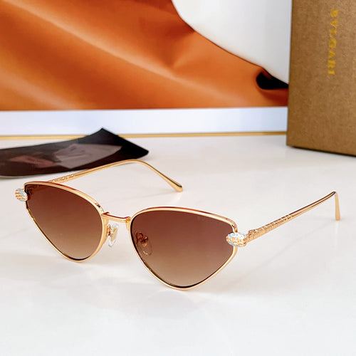 Cat-eye sunglasses with gold-tone frame and brown gradient lenses