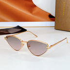 Cat-eye sunglasses with gold-tone frame and light purple gradient lenses