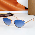 Cat-eye sunglasses with gold-tone frame and blue gradient lenses