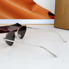 Cat-eye sunglasses with silver-tone frame and black gradient lenses
