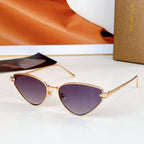 Cat-eye sunglasses with gold-tone frame and dark purple gradient lenses