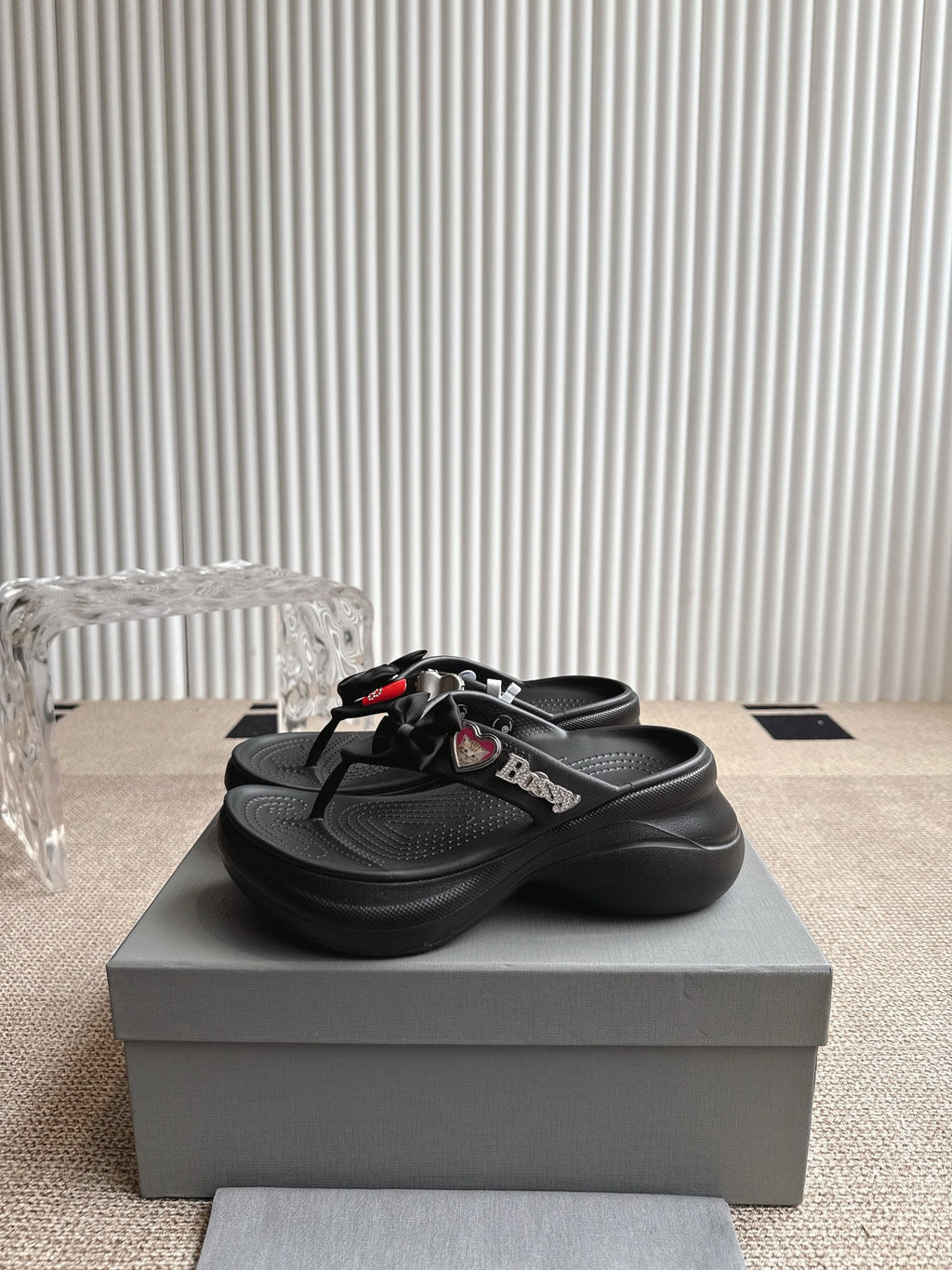 Balenciaga black thong sandals with bow strap detail and textured footbed