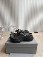Balenciaga black thong sandals with bow strap detail and textured footbed
