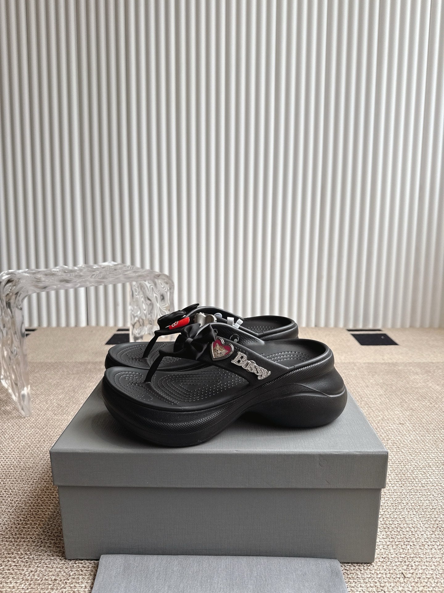 Balenciaga black thong sandals with bow strap detail and textured footbed