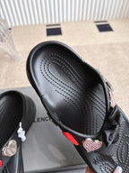 Balenciaga black sandal with textured footbed and bow strap detail, close-up angle