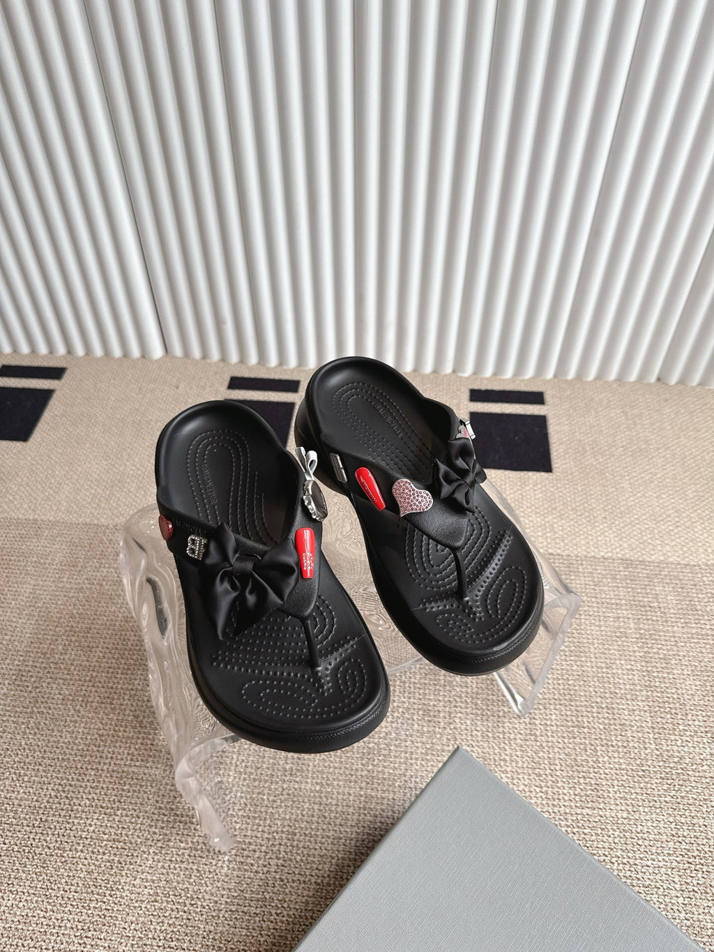 Balenciaga black sandals with bow straps and textured footbed, angled close view