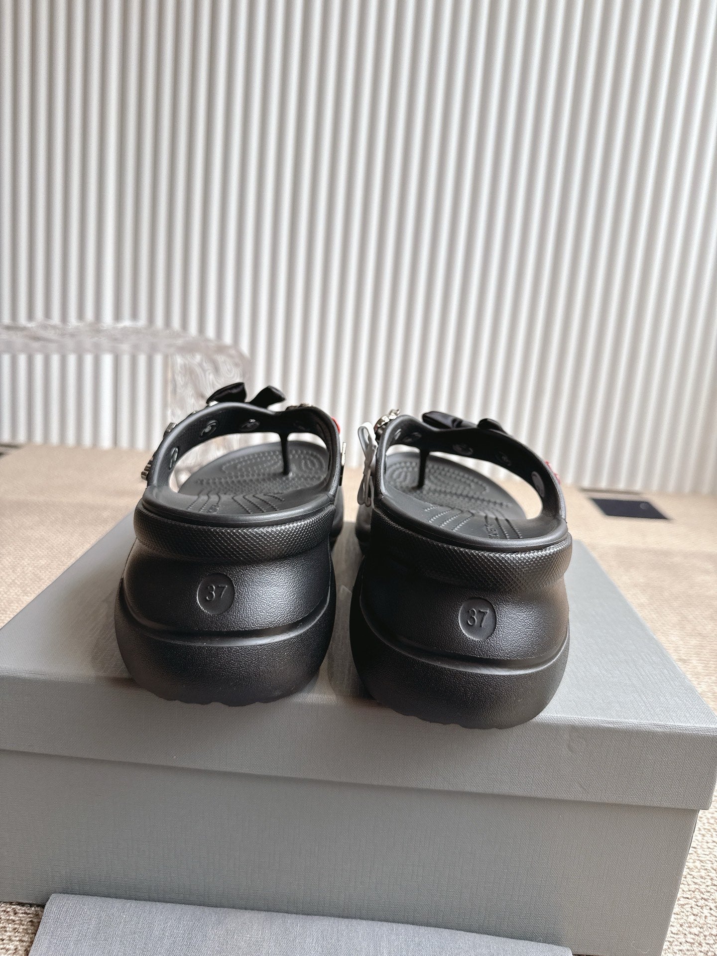 Balenciaga black sandals with back view showing molded heel and strap detail