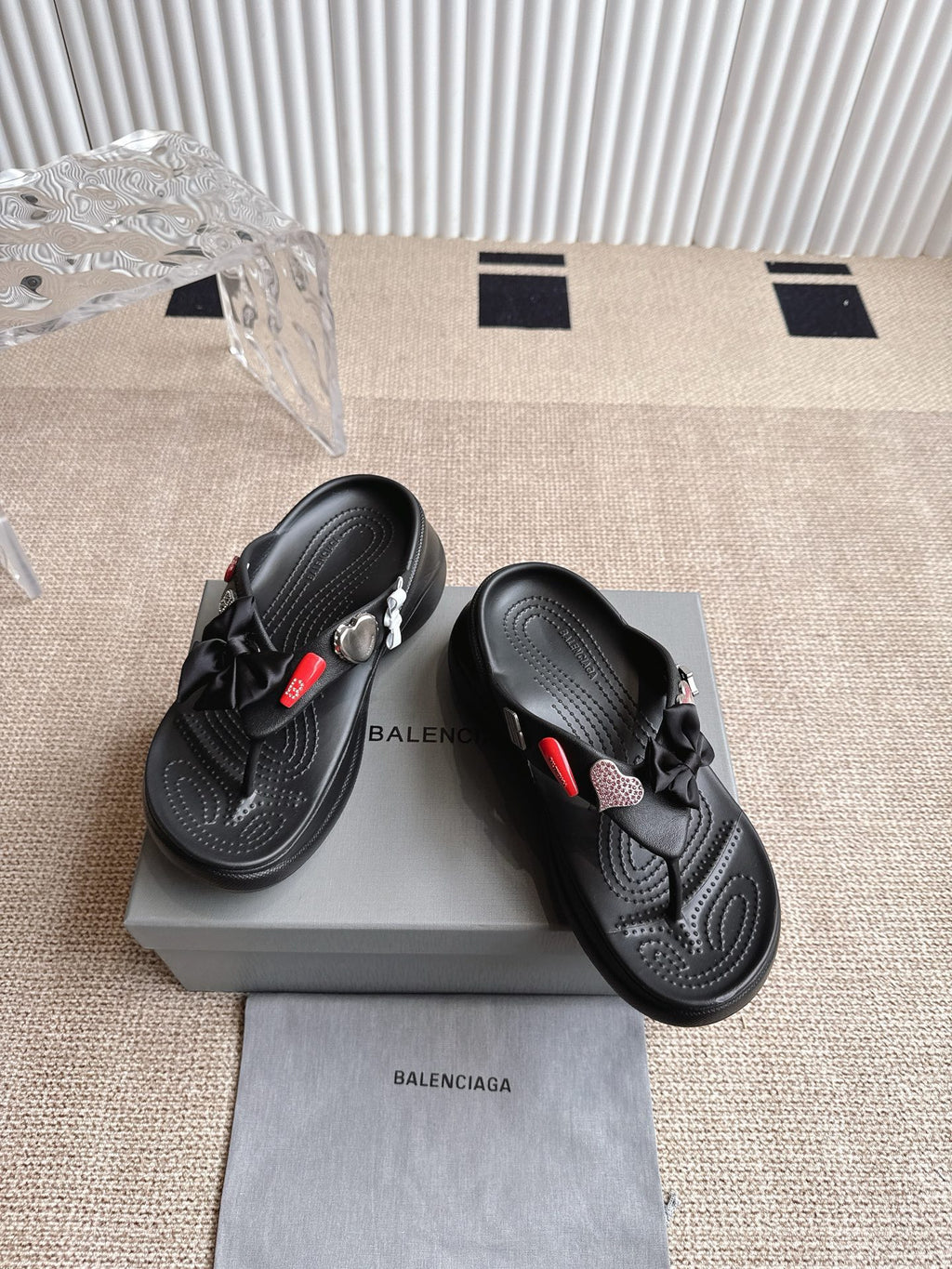 Balenciaga black sandals with bow detail and textured footbed, showing side profile
